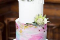 23 a wedding cake with a white tier and a bright watercolor one with gold leaf plus fresh blooms