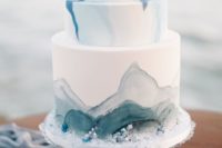 a watercolor grey and blue wedding cake decorated with edible pearls and beads for a seaside wedding
