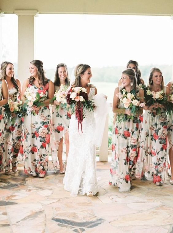 pretty mismatched creamy gowns with red and pink floral prints for a summer wedding