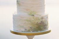 25 abstract, ethereal watercolor stains on a white texured cake for a unique spring-inspired look
