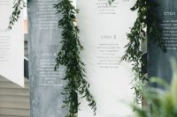 26 black and white geometric seating charts decorated with greenery garlands
