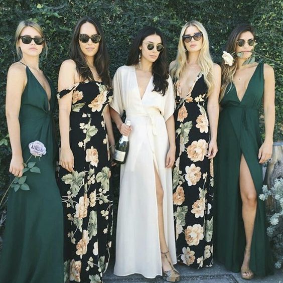 two bridesmaids in dark floral maxi gowns and two in dark green ones for a chic look
