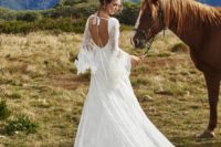 28 country wedding dress with a cutout back, bell sleeves, a full overskirt and a bow on the back