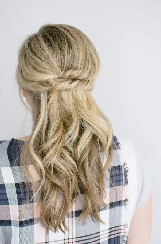 a beautiful half updo with a bump on top, a stacked twist and some waves down is a chic and lovely idea