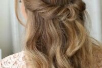 a beautiful looped half updo with waves down and face-framing locks is a cool idea for many styles