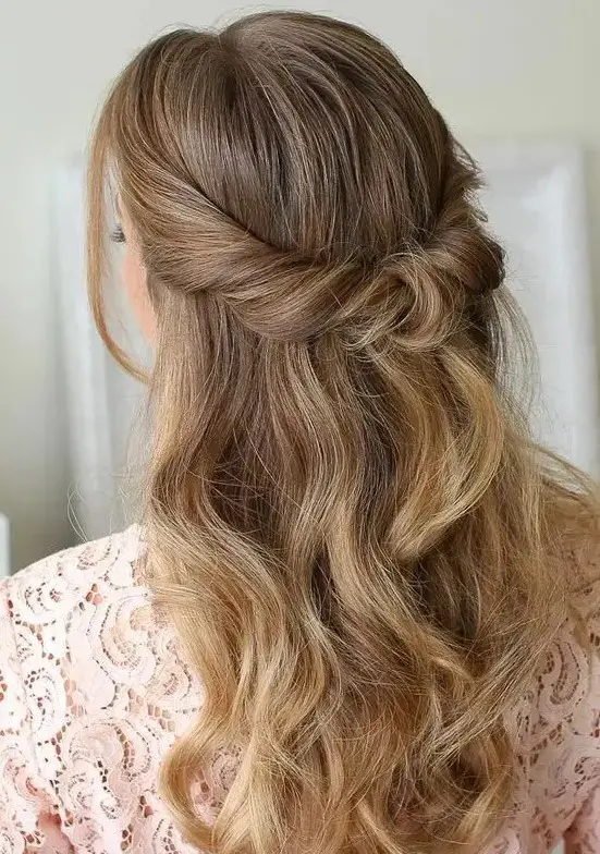 A beautiful looped half updo with waves down and face framing locks is a cool idea for many styles