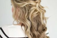 a beautiful messy twisted and wavy half updo with a bump on top and some face-framing locks is amazing for a wedding