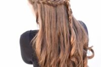 a boho half updo with a braided halo and braid down plus curls is a cool idea to show off the beauty of your locks