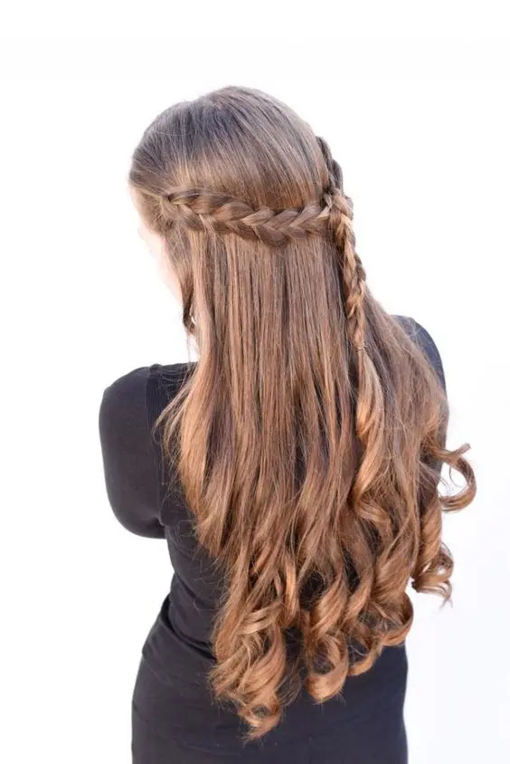a boho half updo with a braided halo and braid down plus curls is a cool idea to show off the beauty of your locks