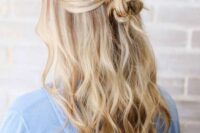 a catchy boho half updo with a messy wrapped knot and waves down plus face-framing locks is cool
