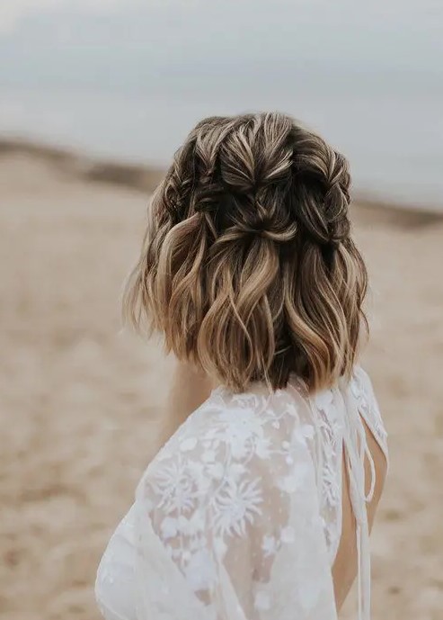 a chic medium half updo with large vertical braids and blonde balayage is a catchy idea for a boho bride or bridesmaid