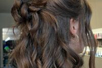 a lovely wedding hairstyle with a top knot