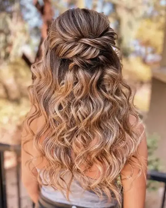 a cool boho wedding half updo with a twisted elements and waves down is a cool boho or rustic wedding hairstyle