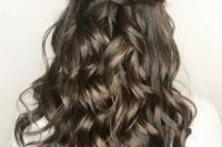a dark brunette half updo with twists and waves down is a cool and chic idea for a wedding, it looks refined and beautiful