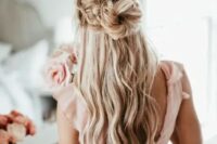 a dreamy half updo with two large braids on top and a top knot plus waves down for a fary-tale look