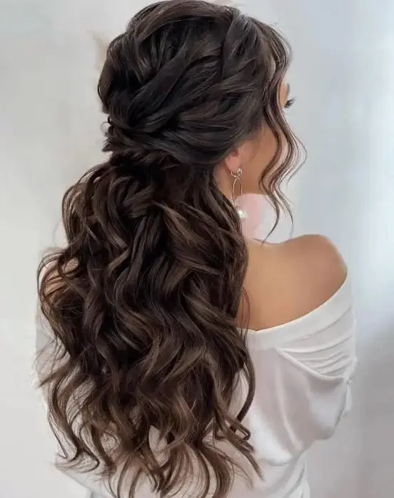 a fantastic wavy twisted half up hairstyle with a wavy top and waves down plus face-framing locks looks gorgeous on long hair