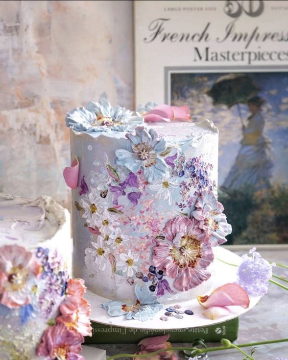 a gorgeous pastel wedding cake decorated with matching sugar blooms in pink, blue and lilac is fantastic