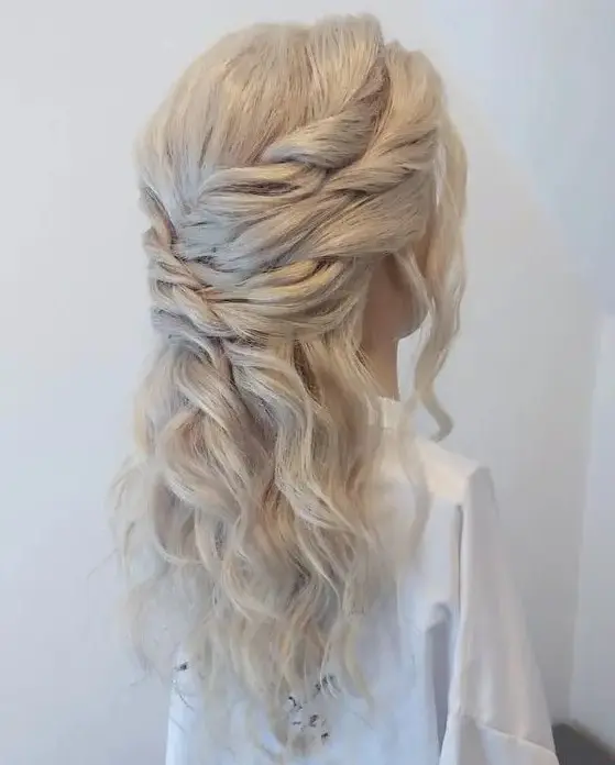 a gorgeous triple twist half updo with waves down and face-framing locks is a cool wedding hairstyle to rock