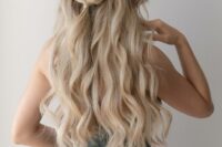 a half updo with a wvy top, a braided touch and waves down is a cool idea for a boho bride