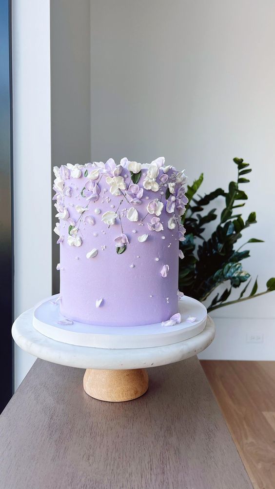 a lilac wedding cake with sugar white and lilac petals and some beads is amazing for a spring wedding