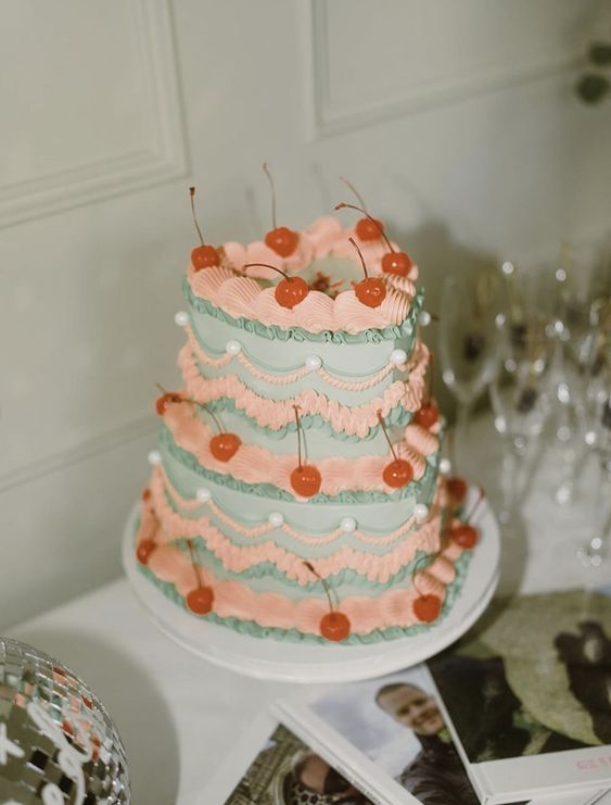 a lovely pastel lambeth wedding cake with lots of detailing, pearls and cherrues is a cool idea for spring