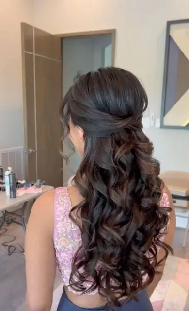 a lush and beautiful dark brunette half updo with a bump on top and waves down plus waves framing the face for a bride or bridesmaid