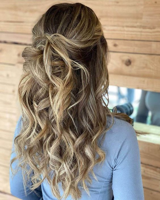 a pretty textured half updo with a bump, waves down and twists is a cool idea for long hair