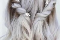 a romantic grey medium half up hairstyle with twisted braids, a darker root for an accent and some waves