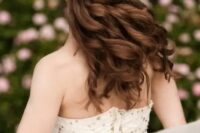 a romantic half updo with a braid on one side and a twist on the second side, with waves down