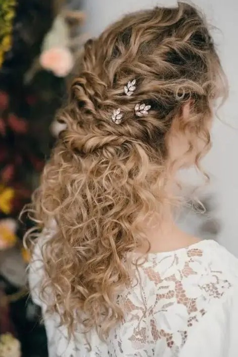 a romantic wedding half updo for naturally curly hair – multiple twists accented with rhinestone hair pins and natural curls down