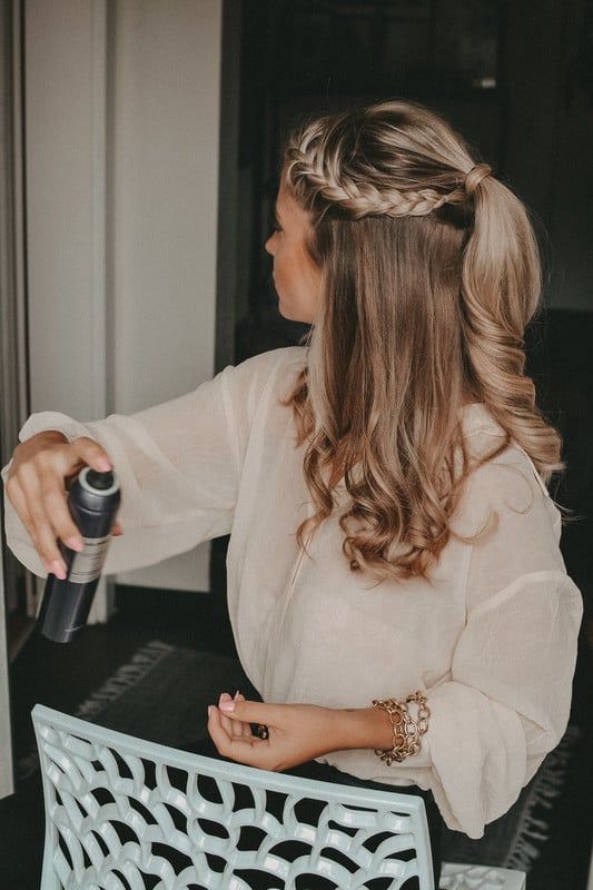 a stylish boho half updo with a ponytail, a braided halo, some curls and waves down is a cool idea for a boho look