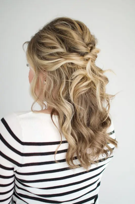 A twisted and wavy half updo with a bump on top, some curls down and face framing hair is amazing