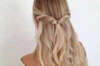 a twisted half updo with an accent braid and waves for a relaxed wedding