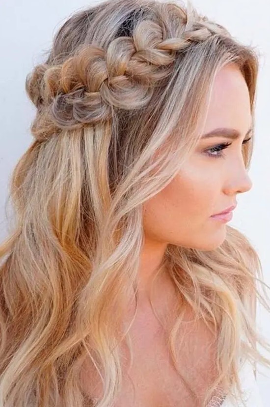 a wavy half updo with a fishtail braided halo and waves down is very romantic and very chic