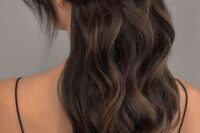 a wavy half updo with a wavy bump on top, with a large braided piece that goes horizontally and waves framing the face
