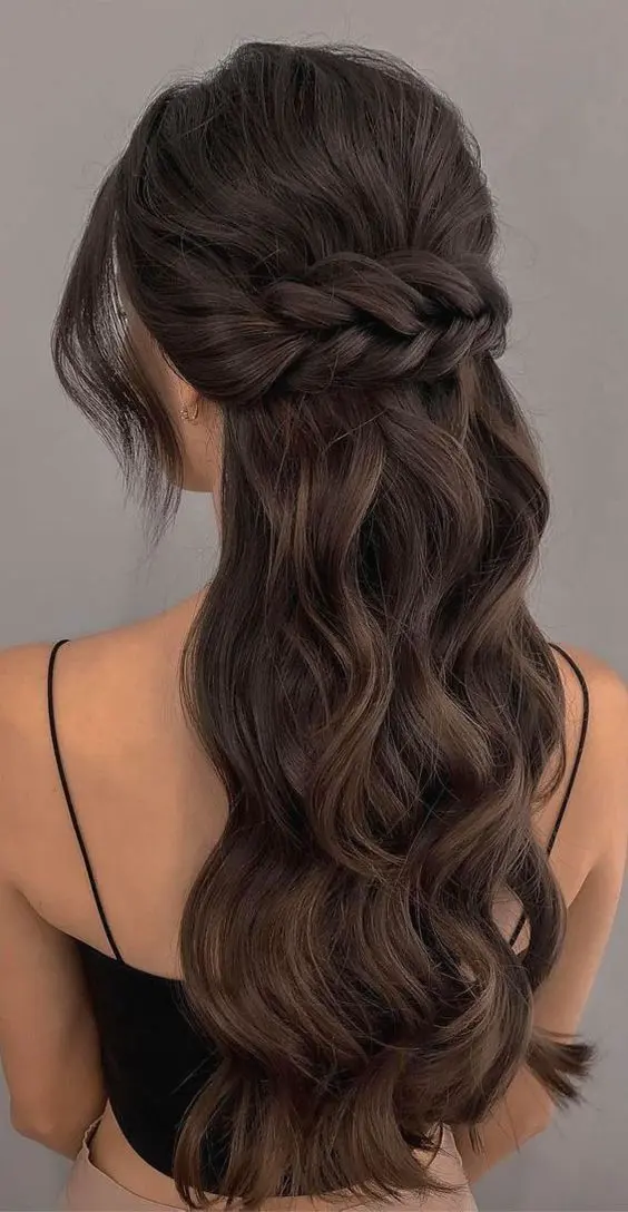 a wavy half updo with a wavy bump on top, with a large braided piece that goes horizontally and waves framing the face