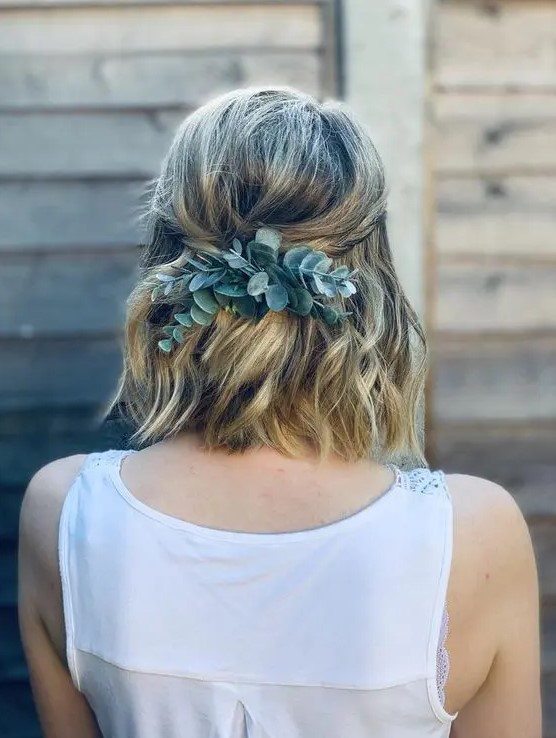 a wavy medium length hairstyle with twists and a touch of fresh eucalyptus is a lovely idea for a boho bridesmaid