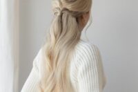 an easy and catchy half updo with a ponytail, a sleek top and waves down is a lovely idea for many weddings