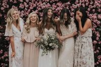 bridesmaids in mismatched floral maxi dresses and in blush ones for a tender and subtle combo