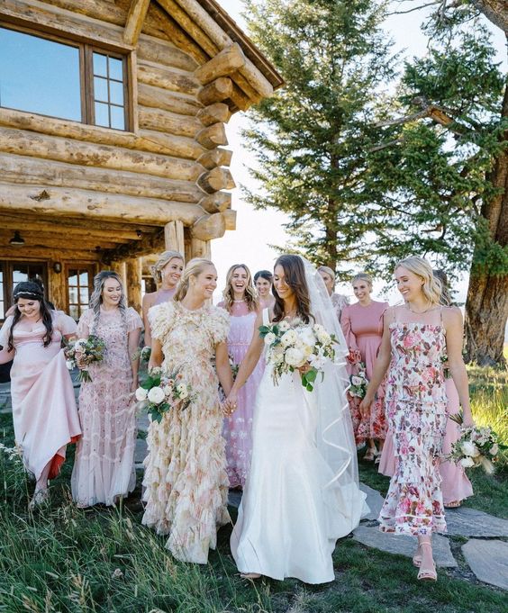 mix and match pink, blush and neutral floral bridesmaid dresses of maxi length for a summer wedding