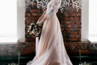 02 a beautiful wedding dress with a white lace applique bodice, long sleeves and a layered blush skirt