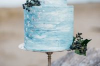 02 a blue watercolor wedding cake decorated with silver leaf and some berries for a coastal wedding