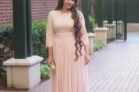 02 a modest blush bridesmaid’s dress with a lace bodice and long sleeves and a maxi skirt
