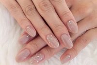 02 nude nails with tiny rhinestones and a whole accent rhinestone nail for a glitter touch