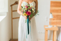 04 She was carrying a very bold and colorful wedding bouquet in the shades of yellow and pink with turquoise ribbons