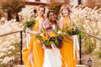 04 The bridesmaids were wearing chic mustard yellow maxi dresses with slits and statement earrings