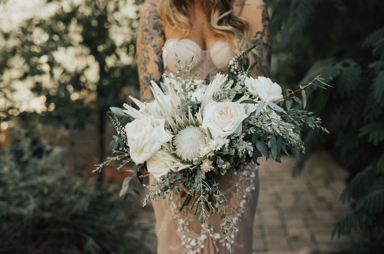 The wedding bouquet was done in creamy tones with greenery to make the dress stand out