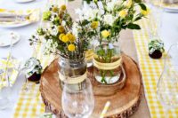 04 a rustic tablescape with a checked yellow and white runner, with yellow and white flowers