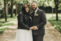 05 The bride covered up with a leather jacket and the groom was wearing a grey three-piece suit and a red tie