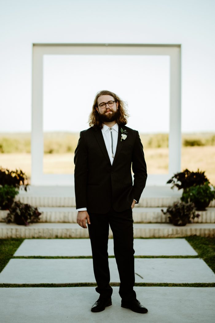 The groom was wearing a tailored suit with a bolo tie and glasses, he looked rather boho chic